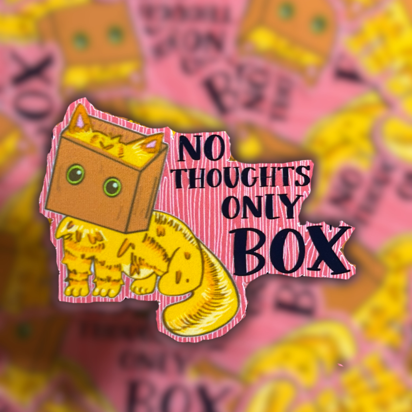 An orange cat with a box over it's head. With the text No Thoughts Only Box